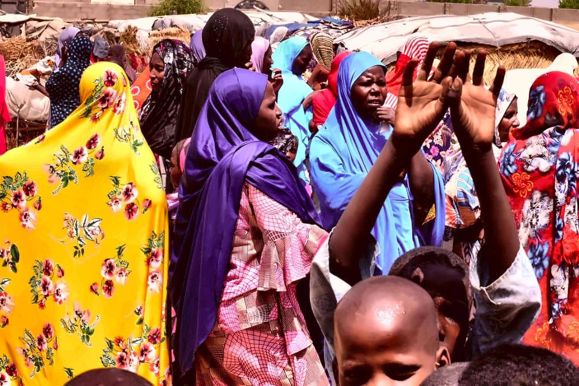 Children reaching out at a Dar Al Ayetam community event
