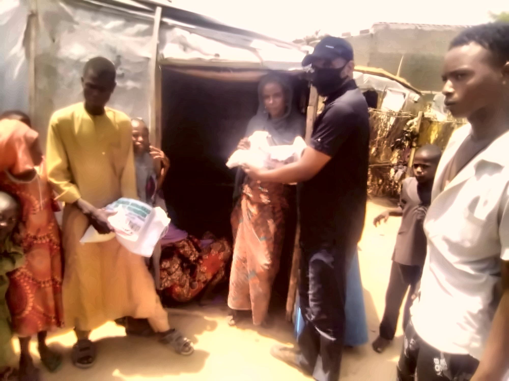 Aid being distributed beside shelters